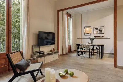 a kitchen with white cabinets and a counter top at Kusku - 3 bedrooms and balcony in Eixample Dreta in Barcelona