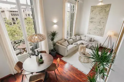a living room with a couch and a table at Agerola - 2 bedrooms in Eixample Dreta in Barcelona