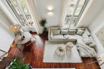 a living room with a couch and a table at Agerola - 2 bedrooms in Eixample Dreta in Barcelona