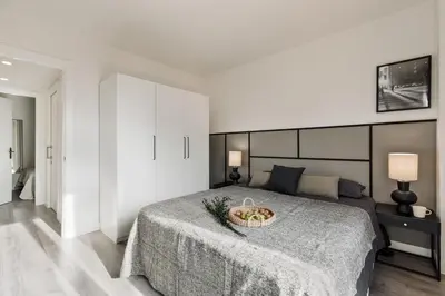 a kitchen with white cabinets and a white refrigerator at Aliga - 3 bedroom and pool in Les Corts in Barcelona