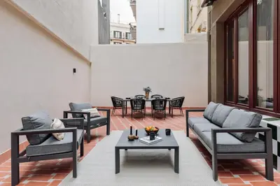 an outdoor patio with couches and tables and chairs at Cliento - 2 bedrooms and terrace in Ciutat Vella in Barcelona
