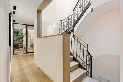 a kitchen and dining room with a wooden table and chairs at Gaudi - 3 bedrooms and terrace in Sant Gervasi in Barcelona