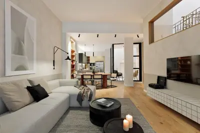 a living room with a white couch and a mirror at Gaudi - 3 bedrooms and terrace in Sant Gervasi in Barcelona