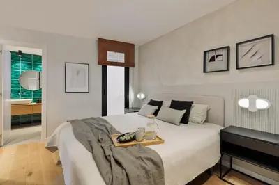 a bedroom with a white bed and two windows at Gaudi - 3 bedrooms and terrace in Sant Gervasi in Barcelona