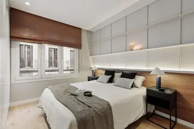 a bedroom with a large glass door leading to a living room at Gaudi - 3 bedrooms and terrace in Sant Gervasi in Barcelona
