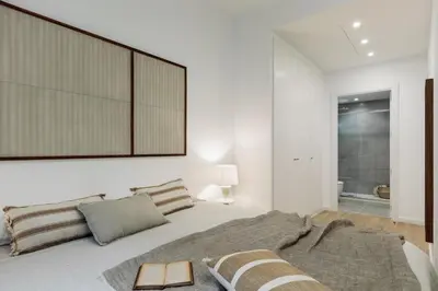 a bedroom with a wooden desk and a bed at Pogerola - 2 bedrooms, balcony and terrace in Ciutat Vella in Barcelona