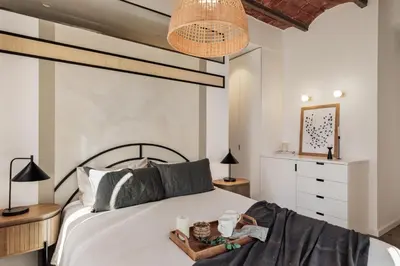 a bedroom with a bed with a book on it at Tamar - 2 bedrooms and terrace in Sant Gervasi in Barcelona
