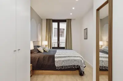 a bedroom with a bed and a large mirror at Cantone - 2 bedrooms, balcony and terrace in Ciutat Vella in Barcelona