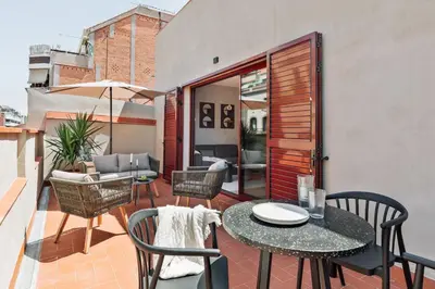 a patio with a table and chairs on a balcony at Kline - 2 bedrooms and terrace in Sant Antoni in Barcelona