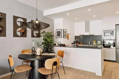 a living room with a table and chairs and a couch at Kline - 2 bedrooms and terrace in Sant Antoni in Barcelona