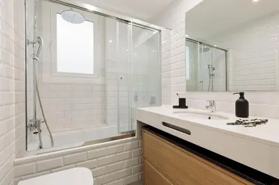 a white bathroom with a sink and a shower at Tikal - 3 bedrooms and balcony in Sant Gervasi in Barcelona
