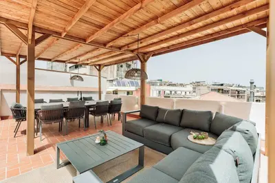 a patio with a couch and a table and chairs at Baronissi - 2 bedrooms and terrace in Ciutat Vella in Barcelona