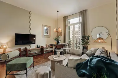 a living room with a couch and a table at Edera - 3 bedrooms and balcony in Eixample Dreta in Barcelona