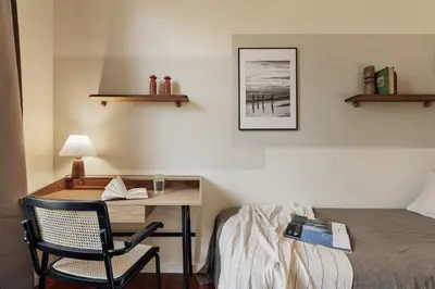 a table with two stools and a basket on it at Edera - 3 bedrooms and balcony in Eixample Dreta in Barcelona