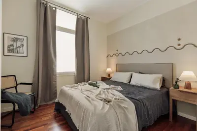 a bedroom with a large bed and two lamps at Edera - 3 bedrooms and balcony in Eixample Dreta in Barcelona
