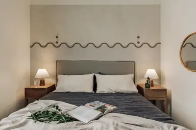 a bedroom with a bed and a chair and a window at Edera - 3 bedrooms and balcony in Eixample Dreta in Barcelona