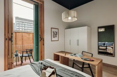 a bedroom with a bed and a mirror at Ada - 2 bedrooms and balcony in Eixample Dreta in Barcelona