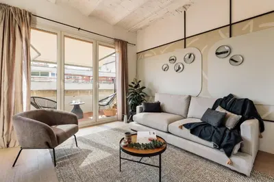 a bedroom with a bed and a table and two mirrors at Solea - 3 bedrooms and balcony in Eixample Dreta in Barcelona