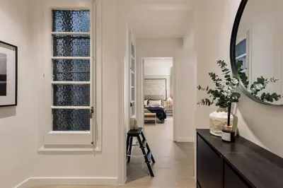 a living room with a chair and a dining area at Solea - 3 bedrooms and balcony in Eixample Dreta in Barcelona