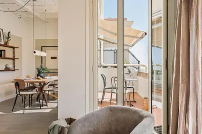 a living room with a couch and a chair at Solea - 3 bedrooms and balcony in Eixample Dreta in Barcelona