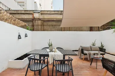 a patio with tables and chairs and a couch at Kayra - 2 bedrooms and terrace in La Sagrada Familia in Barcelona