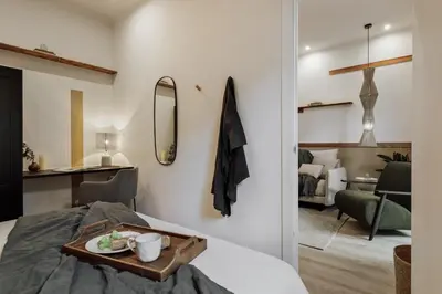 a hallway with a kitchen with a table and two stools at Kayra - 2 bedrooms and terrace in La Sagrada Familia in Barcelona