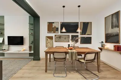 a dining room with a wooden table and chairs at Arlet - 4 bedrooms in Eixample Dreta in Barcelona