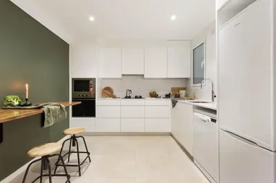 a bedroom with a bed and a night stand with a lamp at Arlet - 4 bedrooms in Eixample Dreta in Barcelona