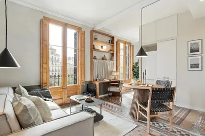 a bedroom with a large bed with a wooden headboard at Serre - Studio in Eixample Dreta in Barcelona