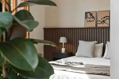 a hotel room with a bed and a plant at Serre - Studio in Eixample Dreta in Barcelona