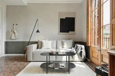 a living room with a couch and a table at Serre - Studio in Eixample Dreta in Barcelona