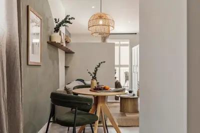 a bedroom with a bed and a table with a lamp at Freso - Studio in Eixample Esquerra in Barcelona