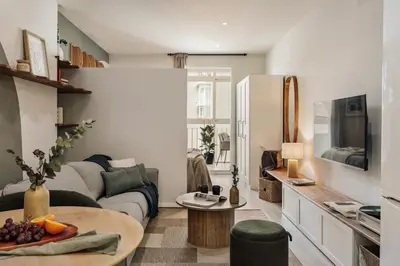 a living room with a couch and a table at Freso - Studio in Eixample Esquerra in Barcelona