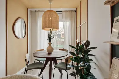 a hallway with white walls and a mirror on the wall at Sariyer - 2 bedrooms and balcony in El Putxet in Barcelona