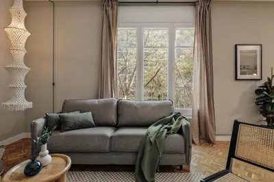 a living room with a couch and a tv at Cahuita - 2 bedrooms and office in Sants in Barcelona