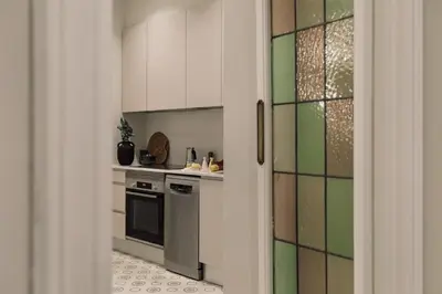 a kitchen with white cabinets and a refrigerator at Cumulus - 2 bedrooms and balcony in Vila de Gràcia in Barcelona