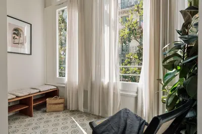 a living room with a couch and a tv at Cumulus - 2 bedrooms and balcony in Vila de Gràcia in Barcelona