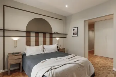 a bedroom with a bed and a lamp on a night stand at Amani - 3 bedrooms in Vila de Gràcia in Barcelona