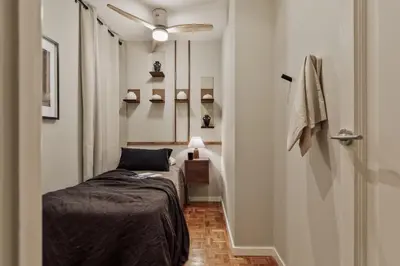a bedroom with a large bed with a wooden headboard at Amani - 3 bedrooms in Vila de Gràcia in Barcelona