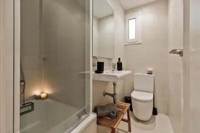 a bedroom with a bed and a table with a lamp at Amani - 3 bedrooms in Vila de Gràcia in Barcelona