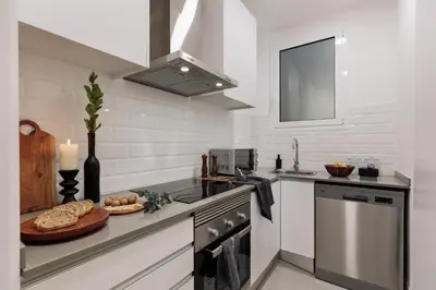 a bathroom with a sink and a toilet at Baru - 2 bedrooms and terrace in Eixample Esquerra in Barcelona