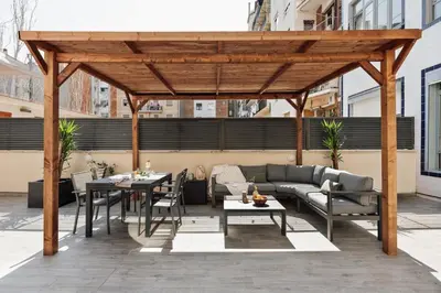 a small bedroom with a bed and a table at Baru - 2 bedrooms and terrace in Eixample Esquerra in Barcelona