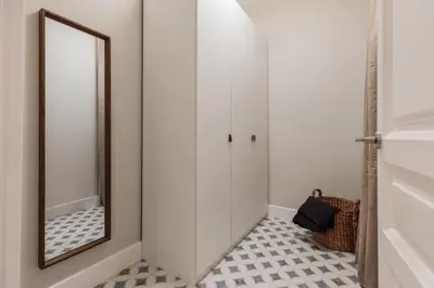 a bedroom with a bed and a mirror at Baru - 2 bedrooms and terrace in Eixample Esquerra in Barcelona