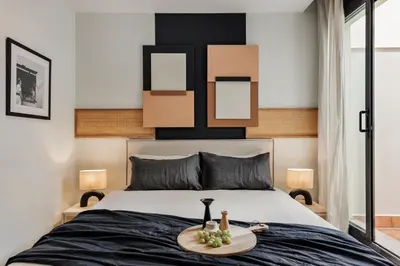 a bedroom with a large bed with a tray on it at Kabatas - 3 bedrooms and patio in Eixample Dreta in Barcelona