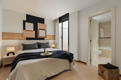 a bedroom with a bed with a wooden tray on it at Kabatas - 3 bedrooms and patio in Eixample Dreta in Barcelona