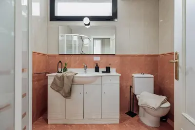 a bathroom with a sink and a toilet at Kabatas - 3 bedrooms and patio in Eixample Dreta in Barcelona