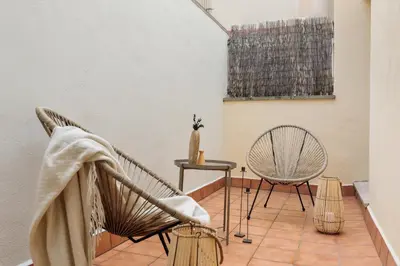 a living room with a couch and a table at Kabatas - 3 bedrooms and patio in Eixample Dreta in Barcelona