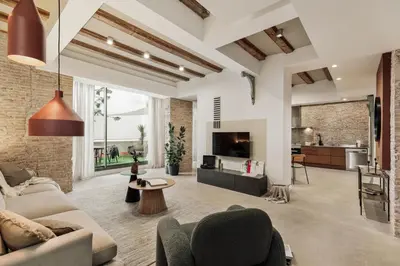 an open living room with a couch and chairs at Galata - 3 bedrooms and terrace in Vila de Gràcia in Barcelona