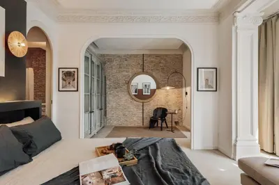 a kitchen with a green door and a brick wall at Galata - 3 bedrooms and terrace in Vila de Gràcia in Barcelona
