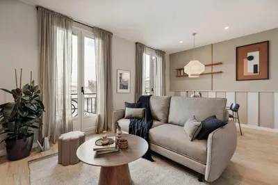 a bedroom with a bed with a large painting on the wall at Davut - 3 bedrooms and office in Eixample Esquerra in Barcelona